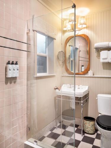 a bathroom with a sink and a glass shower at Le Petit Pali Brentwood in Los Angeles