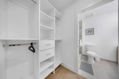 a bathroom with white cabinets and a toilet at Up to 12 guest Modern Villa near Wynwood! 27 in Miami