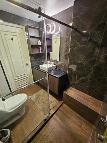 a bathroom with a toilet and a sink at La Fontana Suite #38 in Quito