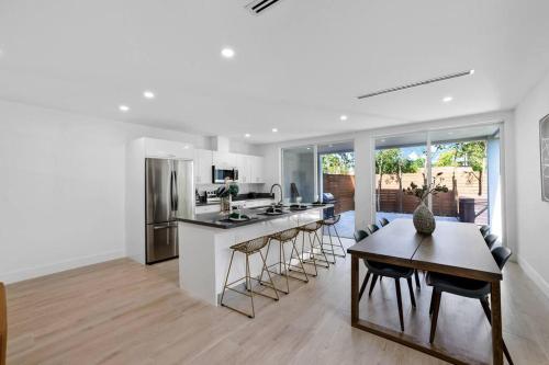 a kitchen and living room with a table and a counter at Up to 12 guest Modern Villa near Wynwood! 27 in Miami