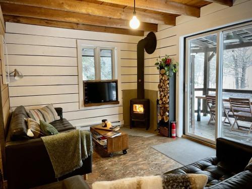 a living room with a couch and a fireplace at Le 10 - Spa Sauna Shower Bromont Lac-Brome in Bromont