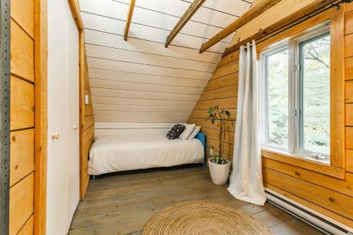 a small room with a bed and a window at Le 10 - Spa Sauna Shower Bromont Lac-Brome in Bromont