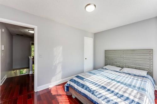 a bedroom with a bed and a large window at Unwind & Relax at Legacy Estates in Stone Mountain