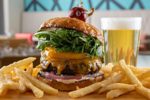 a hamburger and french fries with a glass of beer at Hilton Garden Inn Tacoma Downtown in Tacoma