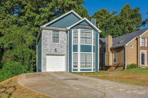 a large blue house with a white garage at Unwind & Relax at Legacy Estates in Stone Mountain