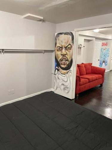 a room with a couch and a painting on the wall at Unwind & Relax at Legacy Estates in Stone Mountain
