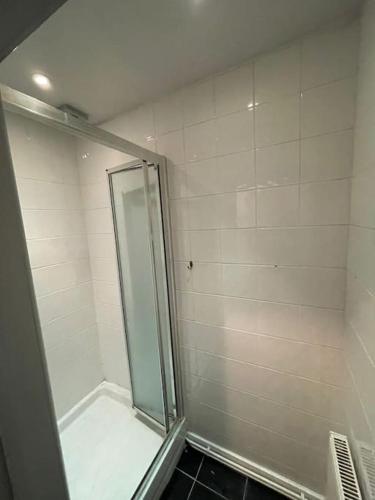 a shower with a glass door in a bathroom at 1 Large Comfy Garden Studio - Prime Location in Brighton & Hove