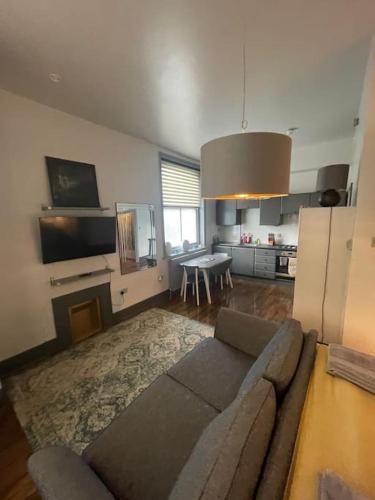 a living room with a couch and a table at 1 Large Comfy Garden Studio - Prime Location in Brighton & Hove