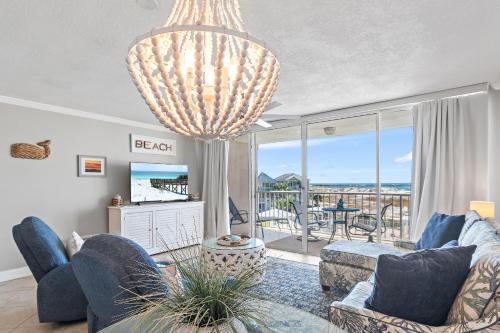 a living room with a large chandelier at Magnolia House 307 At Destin Pointe Resort in Destin