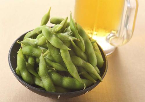 a bowl of green beans sitting on a table at Business Inn Norte in Sapporo