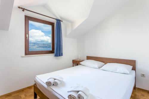 a bedroom with two beds and a window at Apartments by the sea Postira, Brac - 739 in Postira