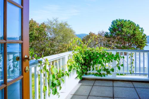 a balcony with a plant on the railing at Sooke Harbour House in Sooke