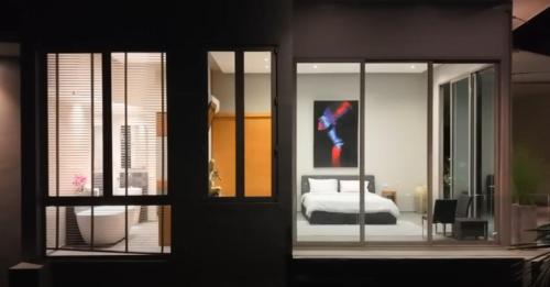 a bedroom with a bed and a painting on the wall at Phuket 4-Bedrooms Seaview 884m2 Private XL Luxury Infinity Pool Villa in Ban Pa Khlok