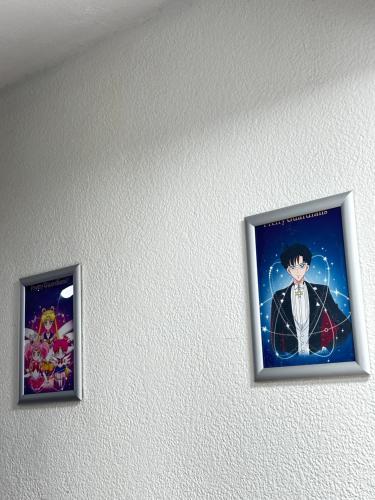 two framed pictures of aichiachi on a wall at Palacio de cristal, Fiesta de cortes 101, Casa Hermar in Puerto Peñasco