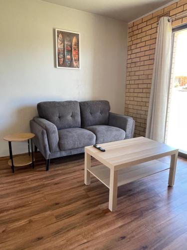 a living room with a couch and a coffee table at Waves Geraldton in Geraldton