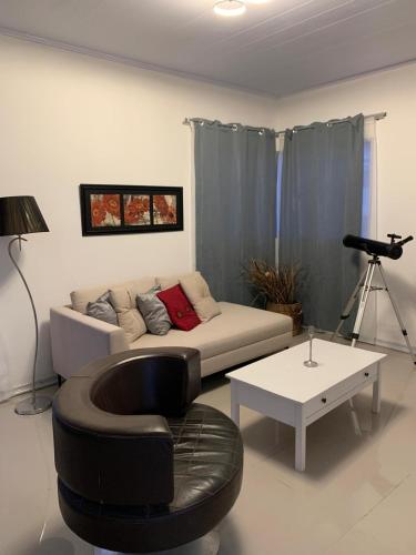 a living room with a couch and a table at La Perla in Nueva Helvecia
