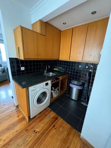 a kitchen with a washing machine and a sink at historic hearth of Bairro Alto in Lisbon