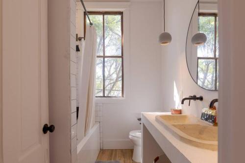 a bathroom with a sink and a mirror at Plum house in Galveston