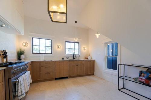 a large kitchen with wooden cabinets and a sink at Plum house in Galveston