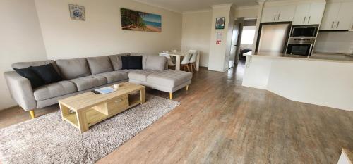 a living room with a couch and a table at Bayview Waters Apartments in Gold Coast