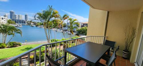 a balcony with a table and a view of the water at Bayview Waters Apartments in Gold Coast