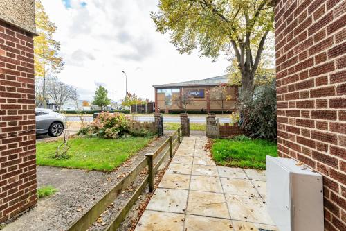 a brick building with a fence next to a yard at Greenview double bedroom 5 in Oxford