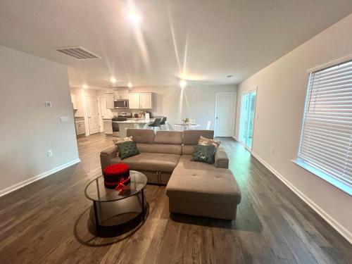 a living room with a couch and a table at Brand New Home in Moor in Moore
