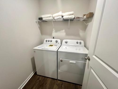 a small laundry room with a washer and dryer at Brand New Home in Moor in Moore