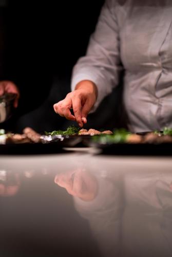 a chef preparing a plate of food on a table at Antiguo Molino de San Jerónimo in Mexico City