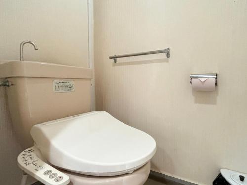 a bathroom with a white toilet with a remote control at Minami Hakone Villa in Kannami