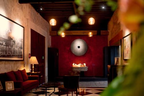 a living room with a couch and a red wall at Antiguo Molino de San Jerónimo in Mexico City