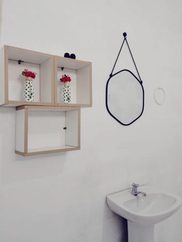 a bathroom with a sink and a mirror on the wall at Suíte Vila das Àguas - 150m da praia in Alter do Chao