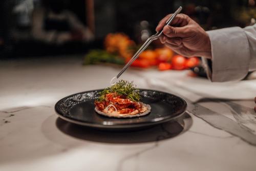 a person eating a plate of food on a table at Antiguo Molino de San Jerónimo in Mexico City
