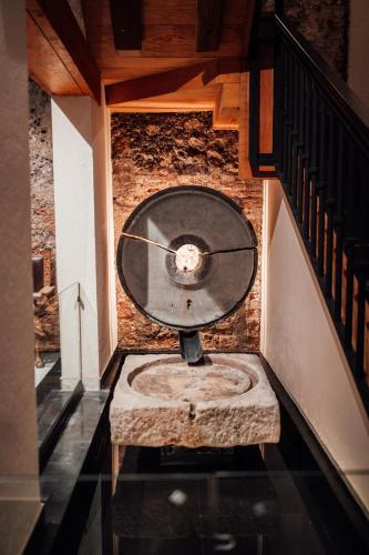 a clock in the middle of a stair case at Antiguo Molino de San Jerónimo in Mexico City
