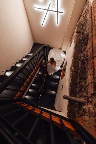 a person walking down a staircase with a cross on the ceiling at Antiguo Molino de San Jerónimo in Mexico City