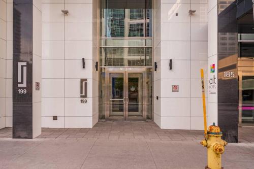 a yellow fire hydrant in front of a building at Luxury 2-Bedroom Penthouse Downtown with Free Parking in Ottawa