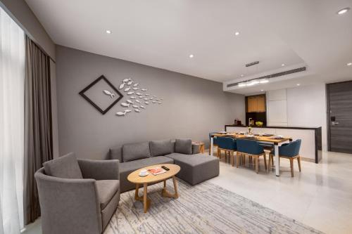 a living room with a couch and chairs and a table at Fraser Place Puteri Harbour in Nusajaya