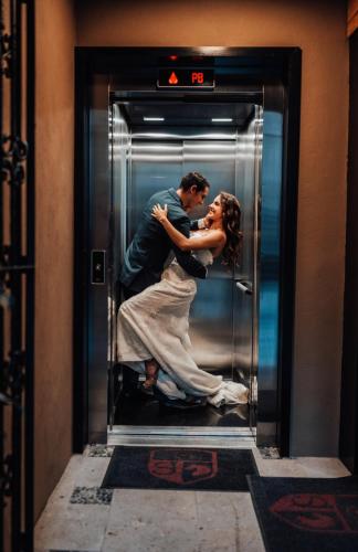 a bride and groom kissing in an elevator at Antiguo Molino de San Jerónimo in Mexico City