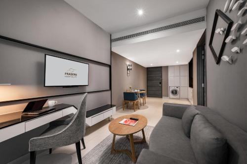 a living room with a couch and a tv at Fraser Place Puteri Harbour in Nusajaya