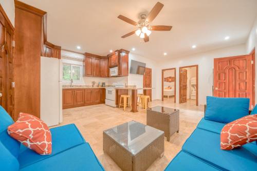 a living room with a blue couch and a ceiling fan at Caribe Tesoro in West Bay