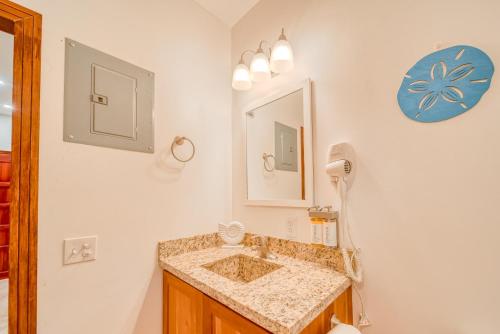 a bathroom with a sink and a mirror at Caribe Tesoro in West Bay