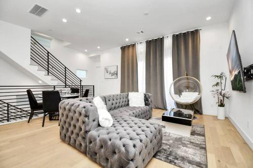 a living room with a couch and a table at BlissHaven Luxe & Spacious in Downtown Houston with Soaking Tub ,Rooftop and free Parking in Houston