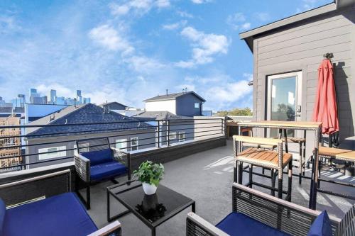 a patio with chairs and tables on a balcony at BlissHaven Luxe & Spacious in Downtown Houston with Soaking Tub ,Rooftop and free Parking in Houston