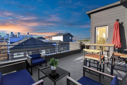 a patio with chairs and tables on a balcony at BlissHaven Luxe & Spacious in Downtown Houston with Soaking Tub ,Rooftop and free Parking in Houston