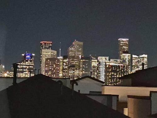 a view of a city skyline at night at BlissHaven Luxe & Spacious in Downtown Houston with Soaking Tub ,Rooftop and free Parking in Houston
