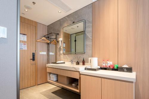 a bathroom with a sink and a mirror at Dayin Youth Hostel - Old Town & People's Square& Rail Hub -Social Area -Bar -Café -Gym -Free Laundry Luggage Storage -24H Front Desk -English Service in Shanghai