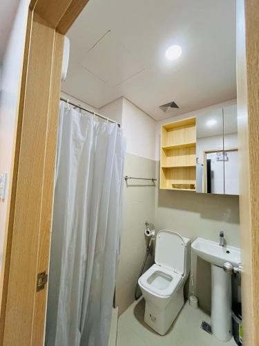 a bathroom with a toilet and a sink at Prima at Primavera City, CDO in Cagayan de Oro