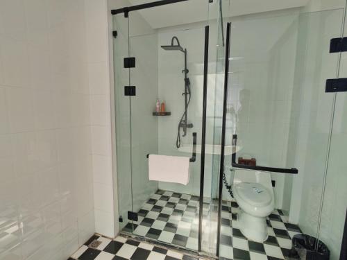 a bathroom with a glass shower and a toilet at Vangvieng Lina hotel in Vang Vieng