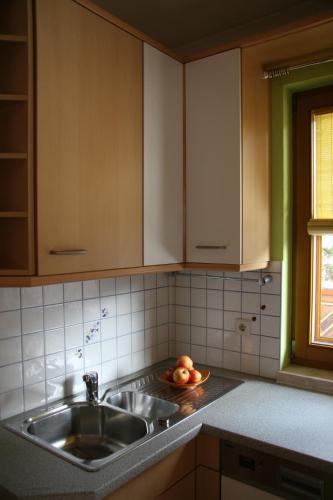 a kitchen with a sink and a bowl of fruit at Familien Zeit in Bad Mitterndorf