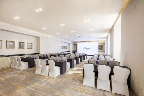 a conference room with tables and chairs and a screen at Fairmont Beijing - 20 minutes to Forbidden City by metro in Beijing
